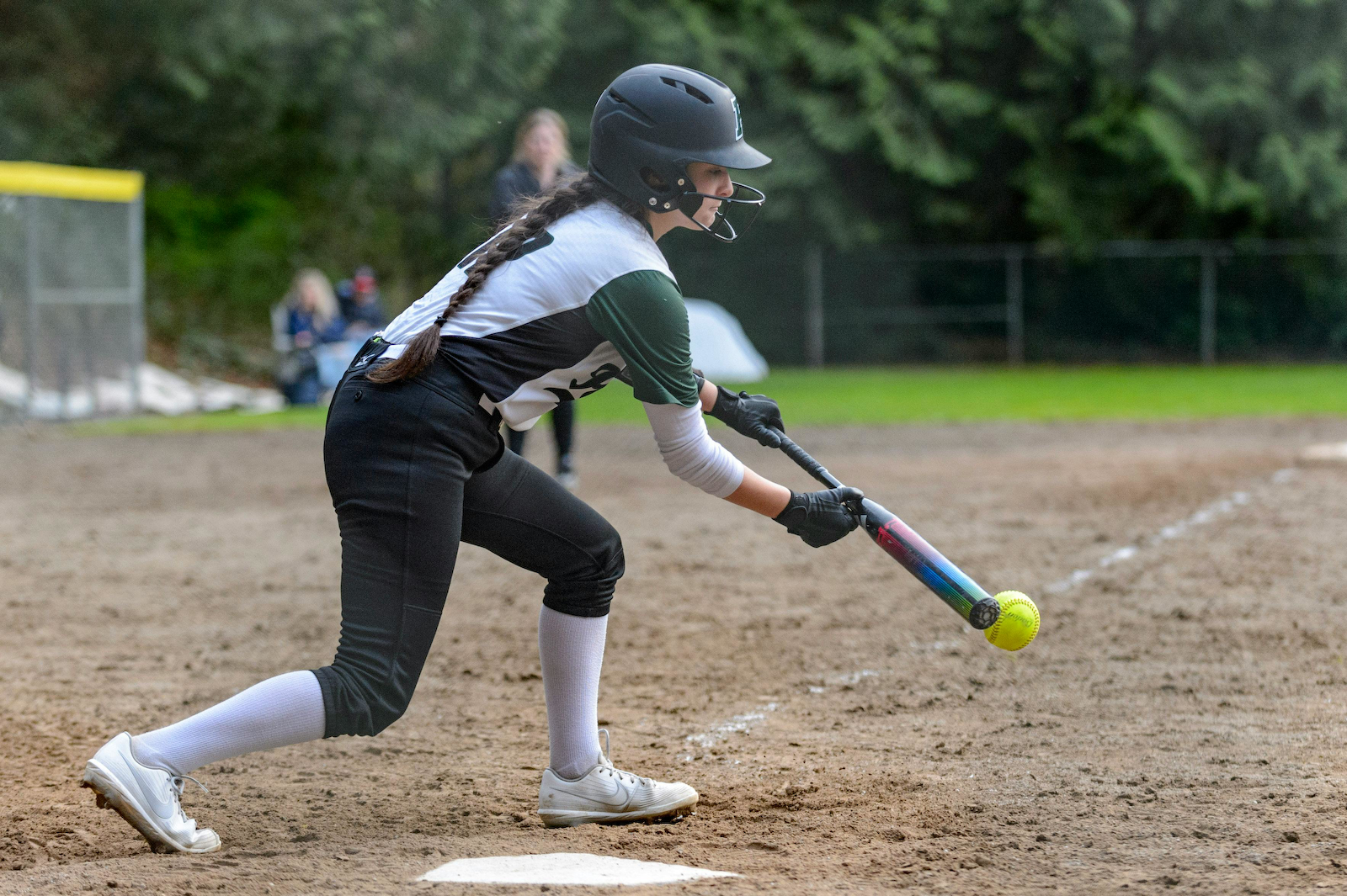Softball player bunts the softball