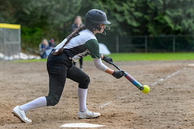 Softball player bunts the softball