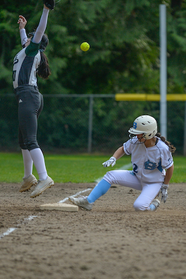 Softball player slides into base.